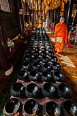 Chiang Mai - The Wat Phan Tao temple, Inside the Wihan: the 108 alm bowls for collecting the offers of coins.  